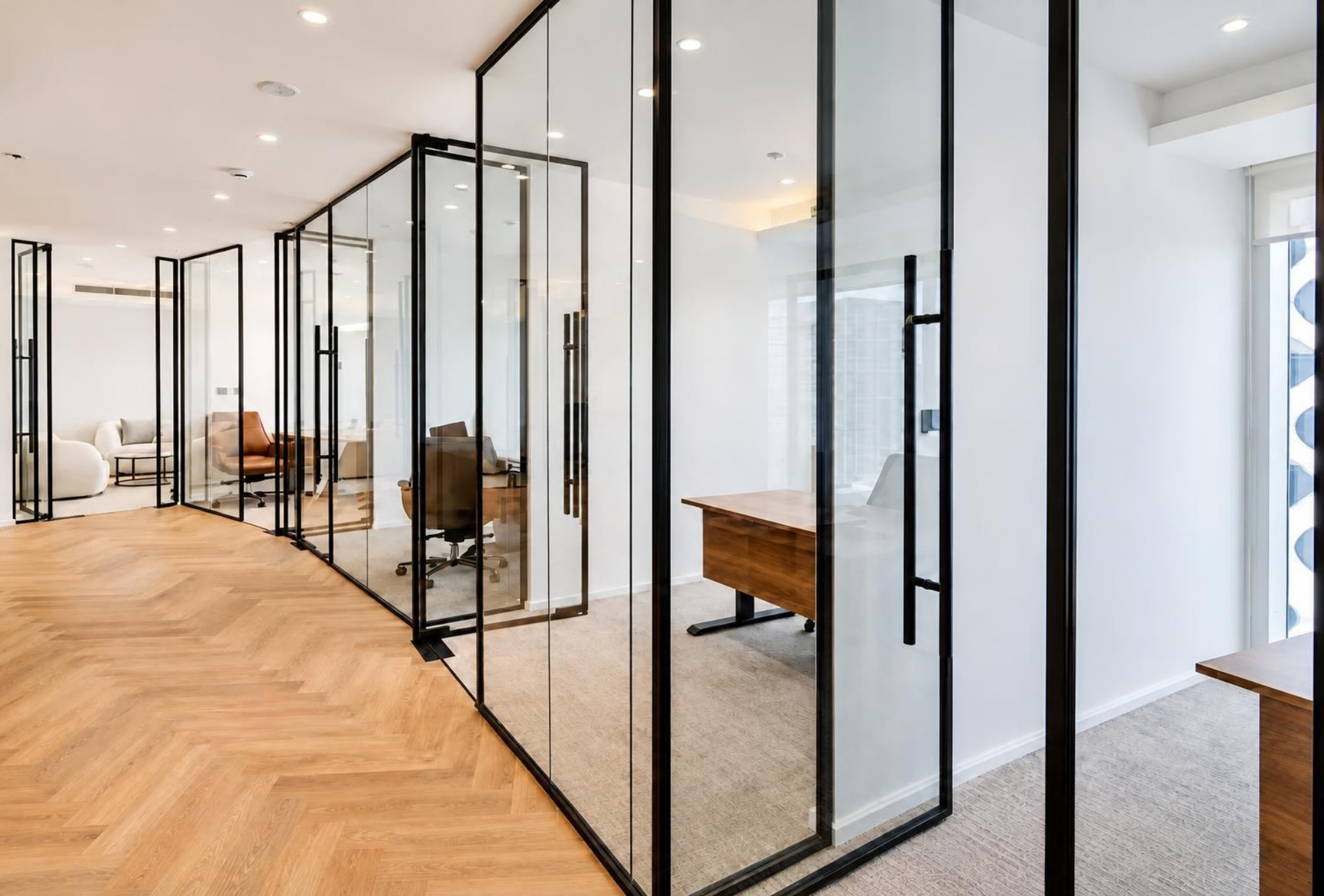 Glass-fronted cabins along the corridor of the Magnum Opus Bay office