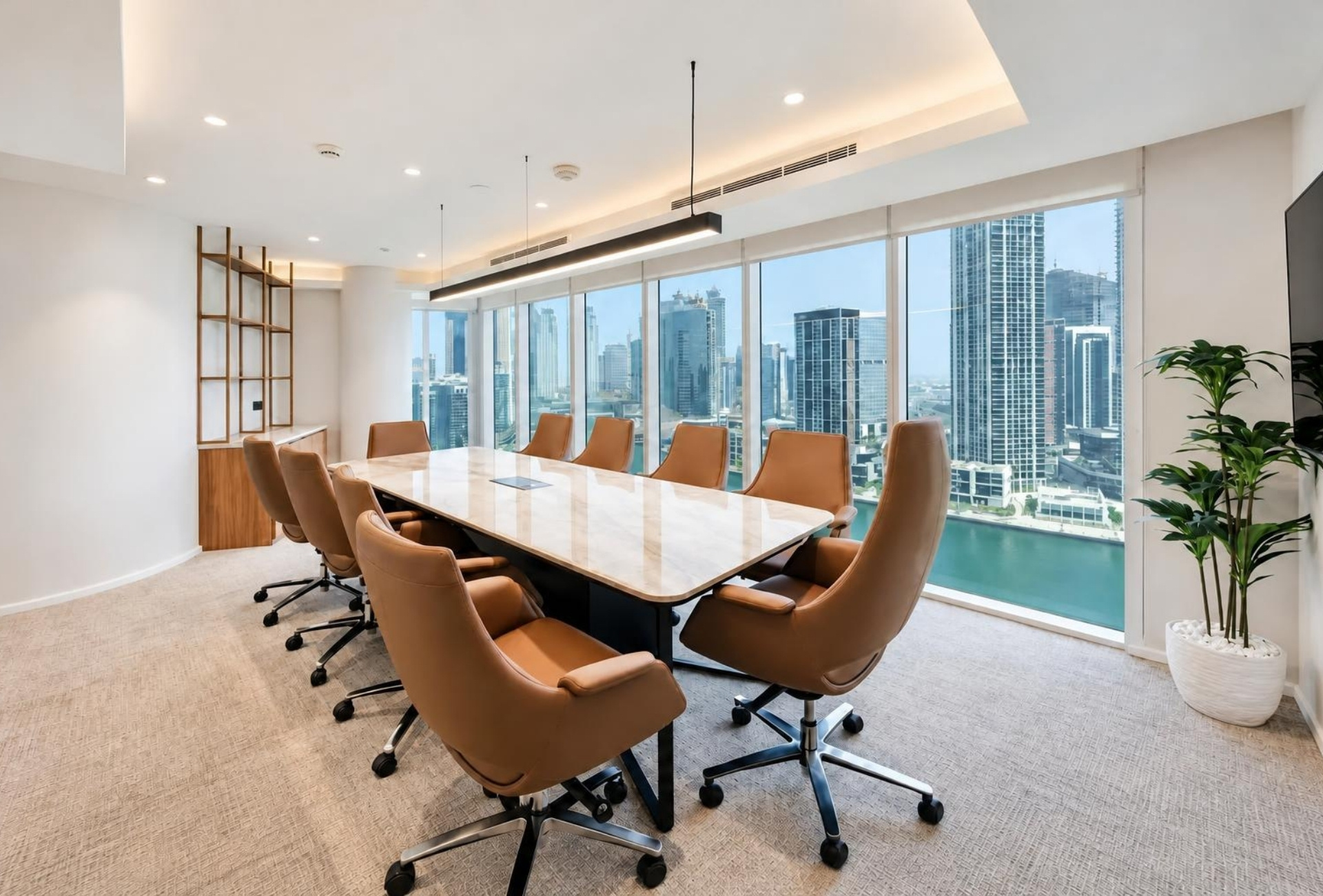 Meeting room with long table and Business Bay view in Magnum Opus Bay