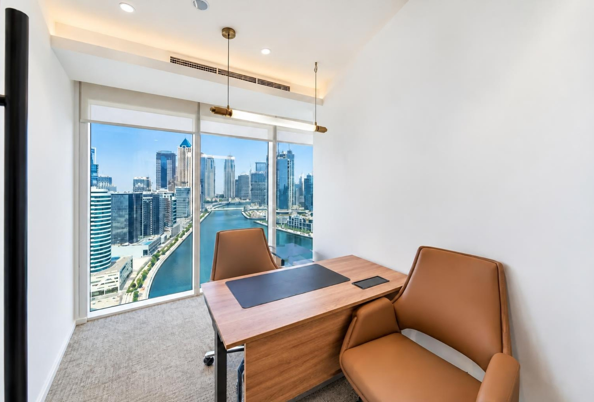 Manager cabin with desk and canal view in Magnum Opus Bay office